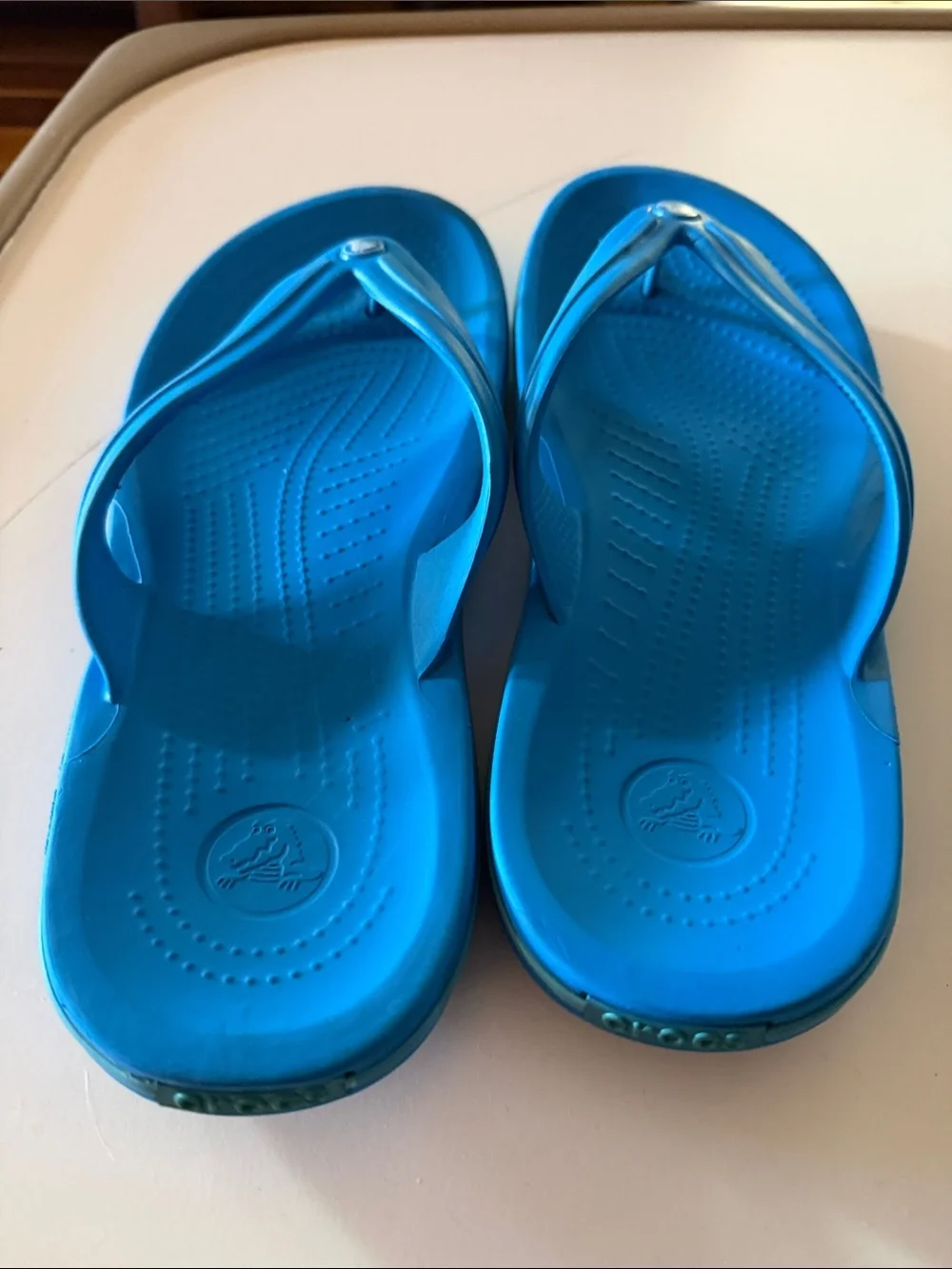 CROCS blue flip flops.  Men’s size 10. Fair condition.